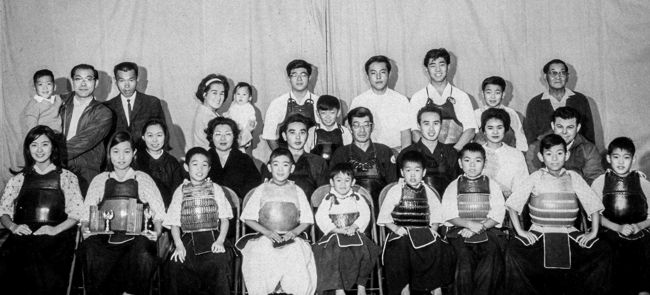 The kendo class in 1965, in bogu, with their instructors