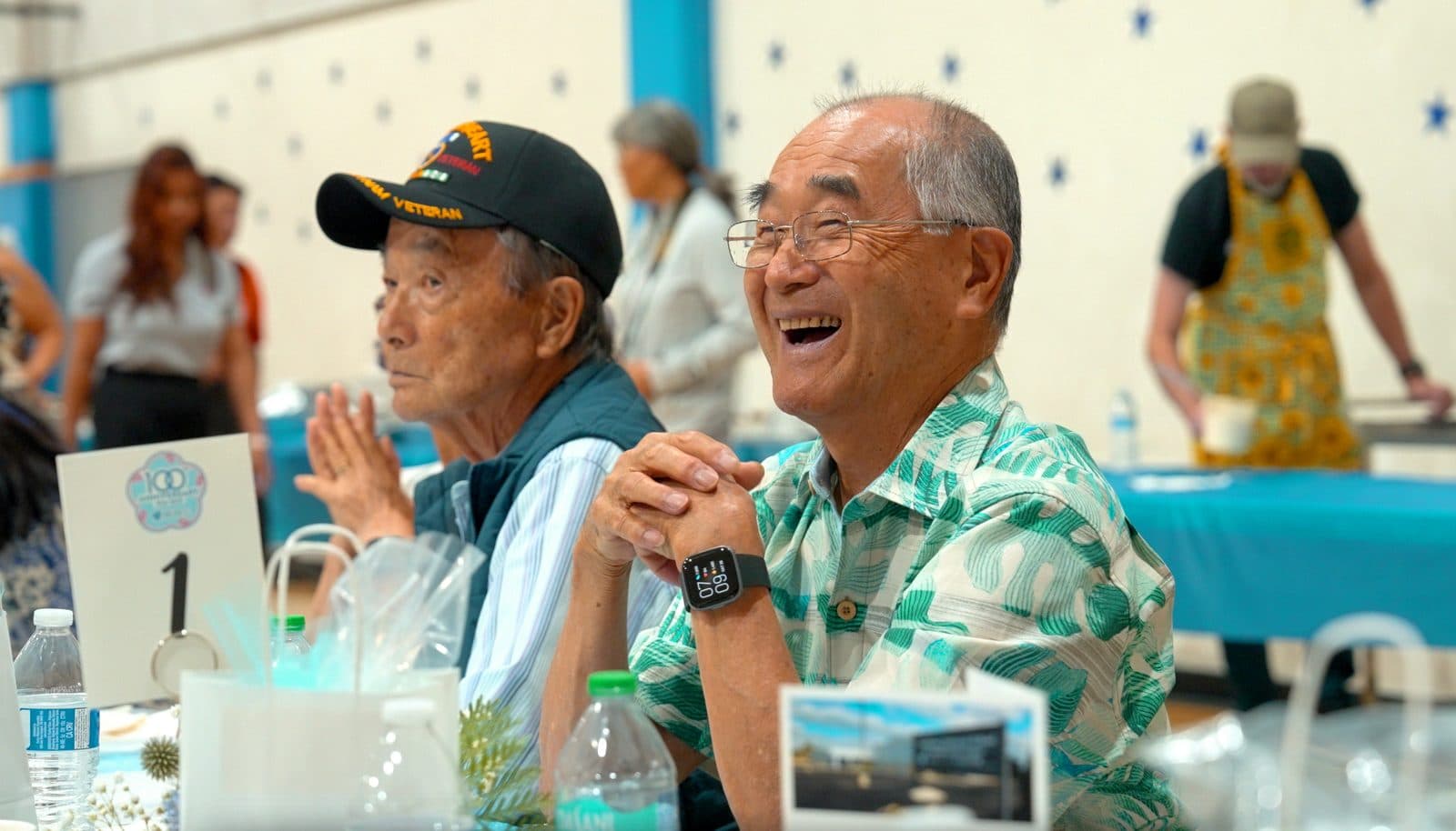 Two older men sharing a laugh at their table