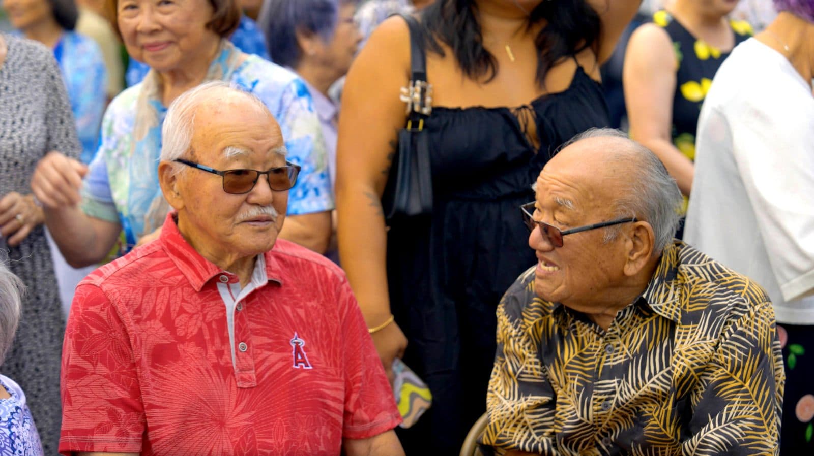 Two longtime members catching up in the crowd