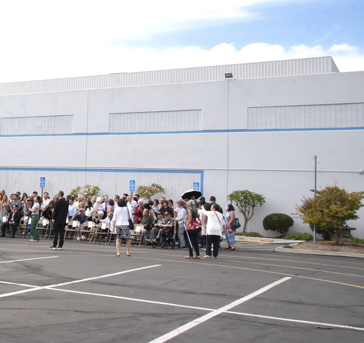 The community gathered outside the center's buildings on a clear afternoon